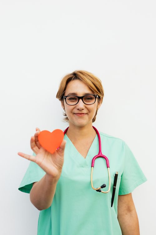 Healthcare professional holding a heart symbol